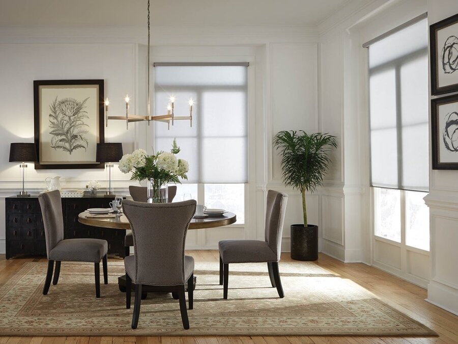  A dining room area featuring two windows with motorized shades.