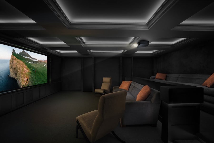 A personal home theater system featuring recliner seating and a large screen display. 
