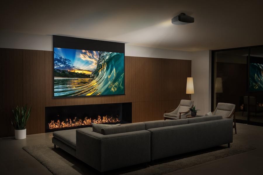 A Sony projector displays an ocean wave scene in a custom home theater.