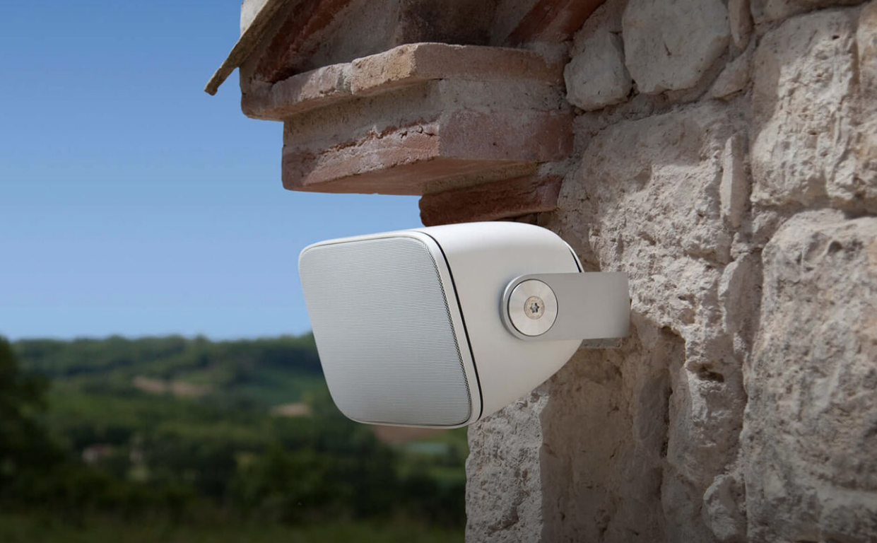 A Sonance outdoor speaker mounted on an exterior wall.
