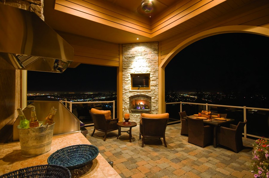 A roofed outdoor area overlooking the city at night.
